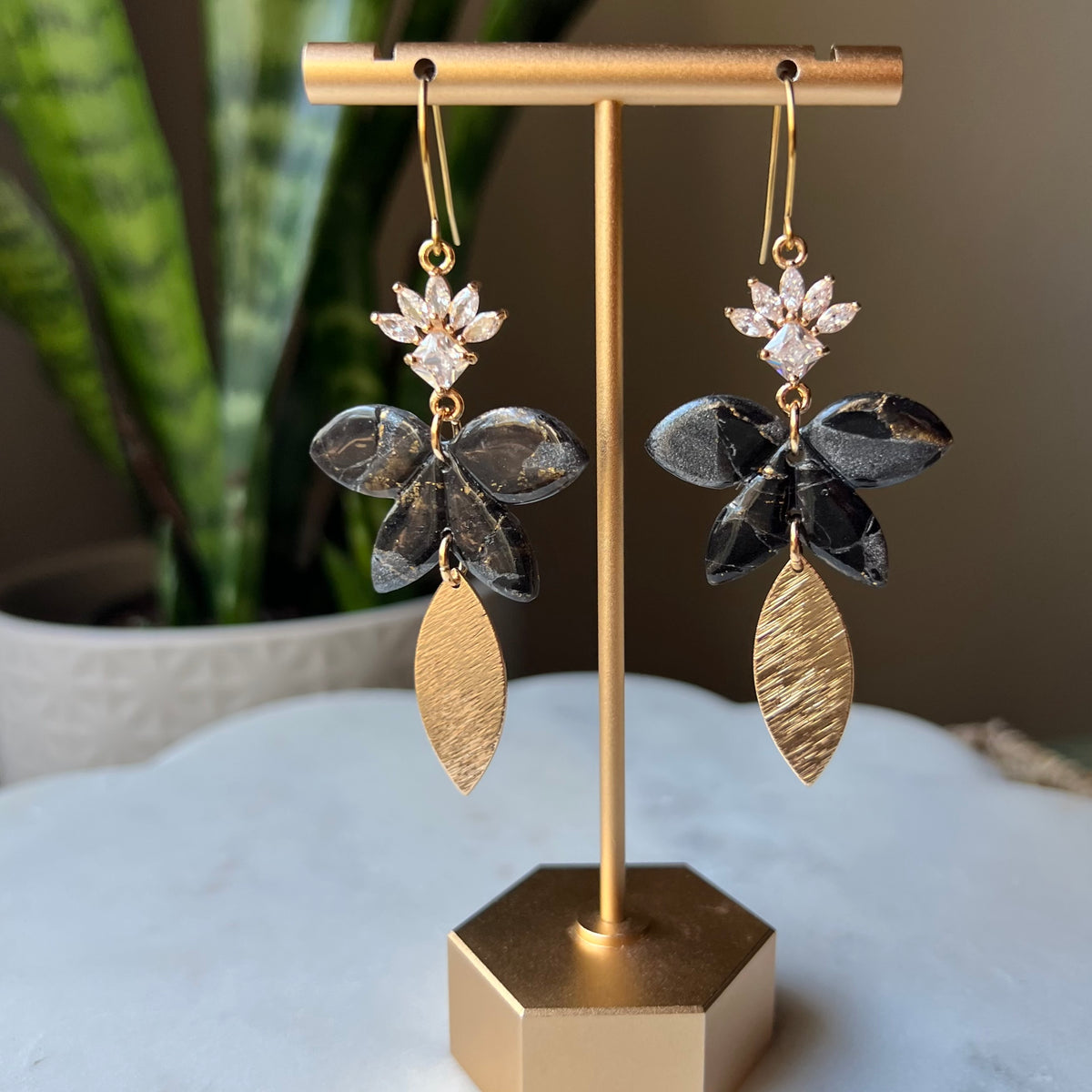Black floral polymer clay dangle earrings with CZ flower and textured gold leaf