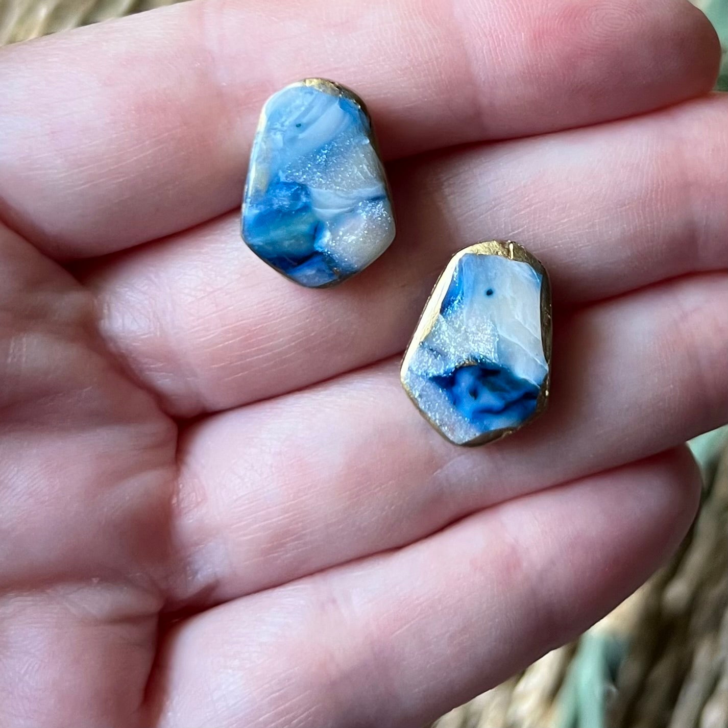 The Marina polymer clay statement stud earrings in ocean blue with gold edges, lightweight and coastal-inspired.