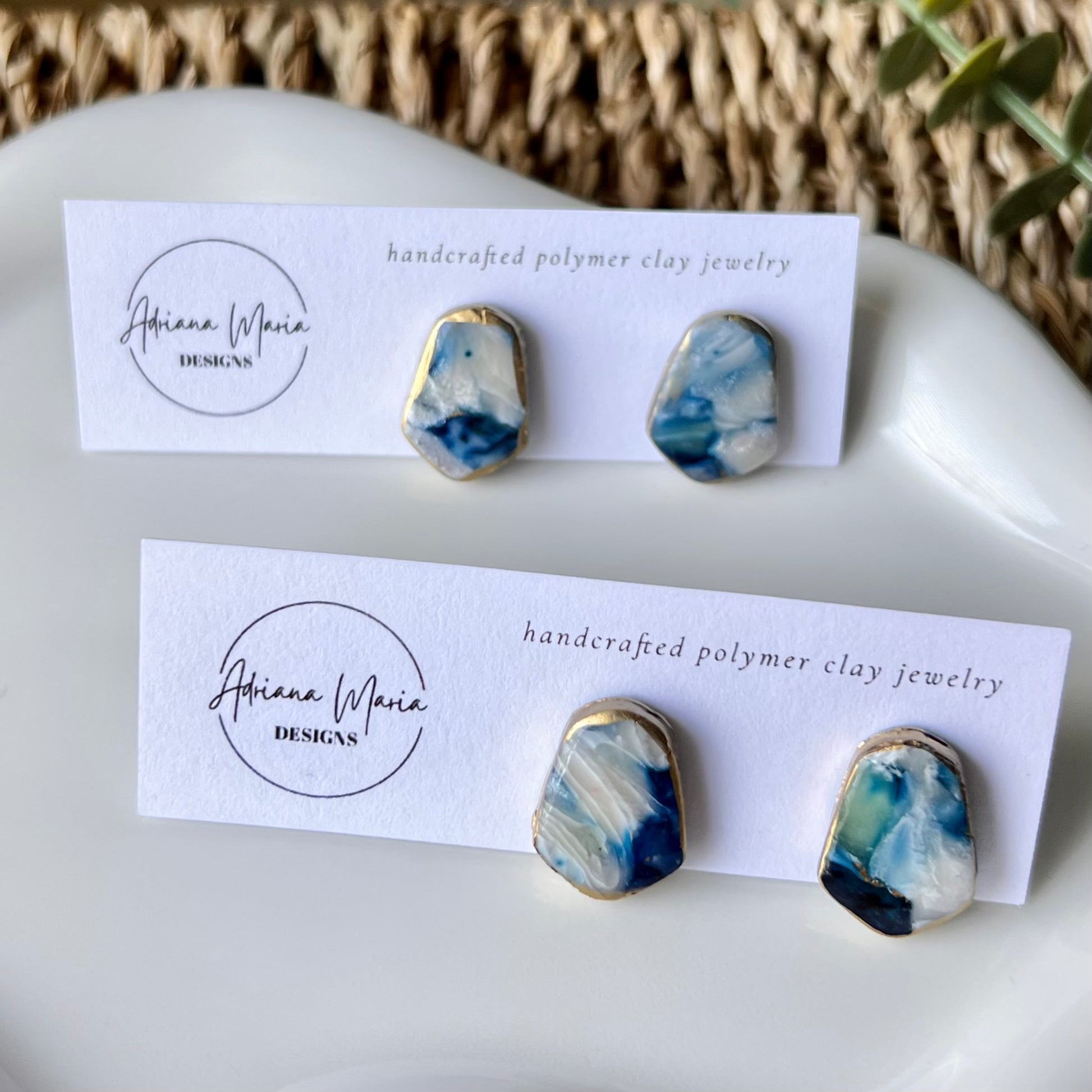 The Marina polymer clay statement stud earrings in ocean blue with gold edges, lightweight and coastal-inspired.