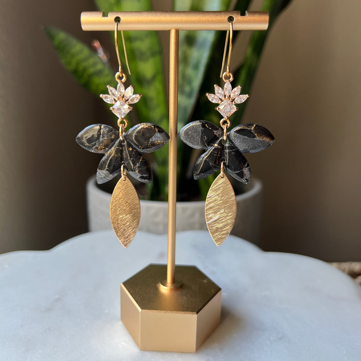 Black floral polymer clay dangle earrings with CZ flower and textured gold leaf
