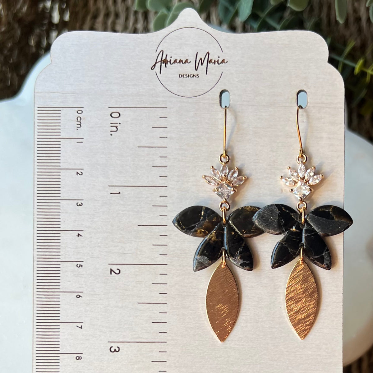 Black floral polymer clay dangle earrings with CZ flower and textured gold leaf