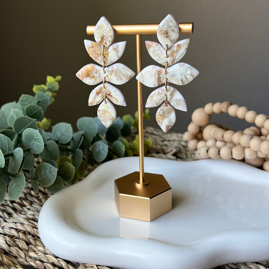 earrings hanging from earring display 