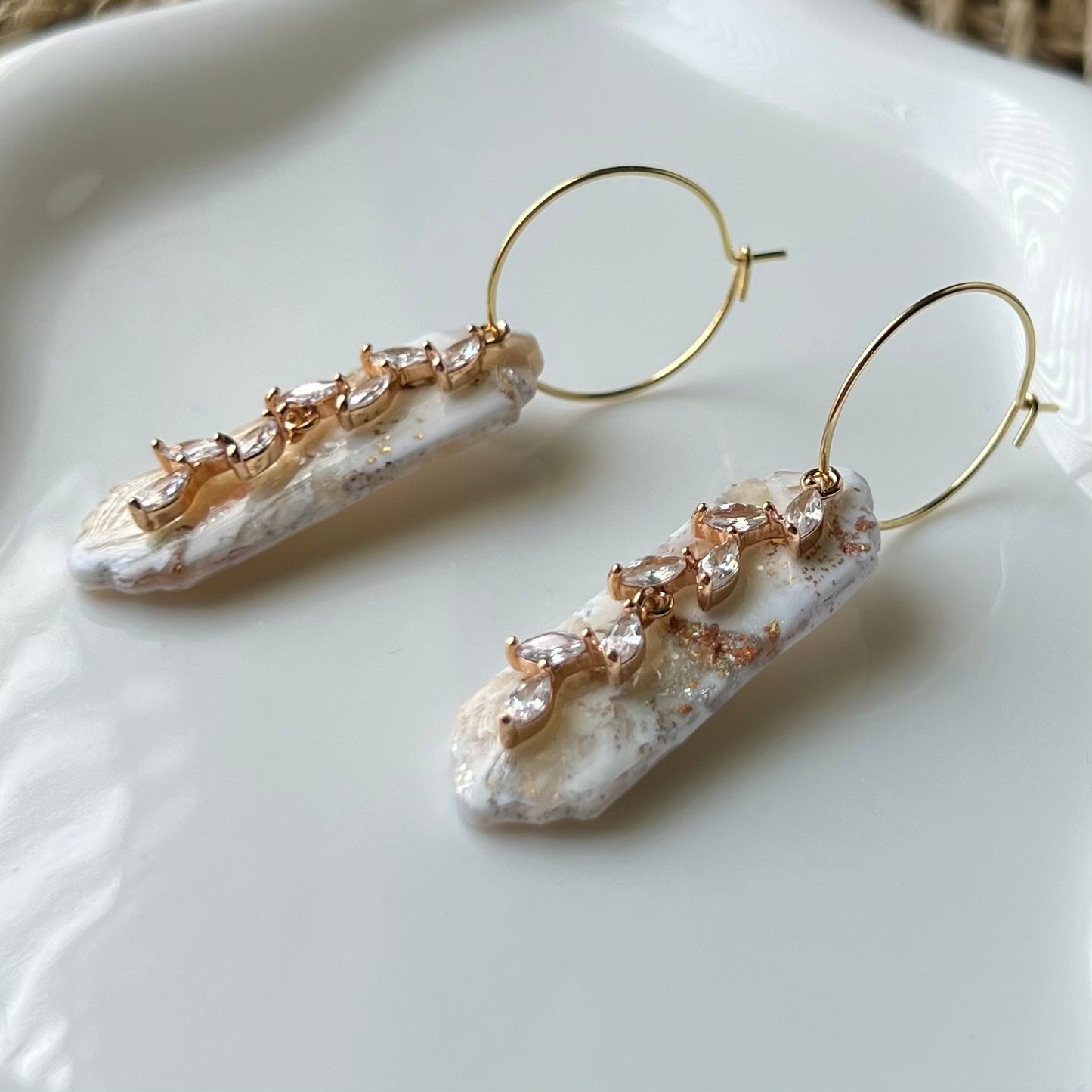 Marbled ivory clay with mixes of gold and silver colors with gold colored stainless steel hoops and cubic zirconia “vine” pendant 