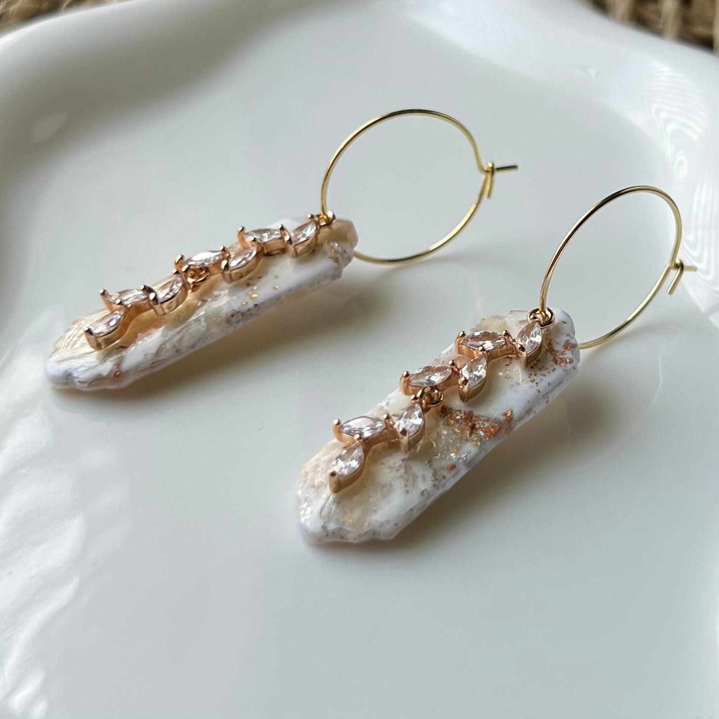 Marbled ivory clay with mixes of gold and silver colors with gold colored stainless steel hoops and cubic zirconia “vine” pendant 